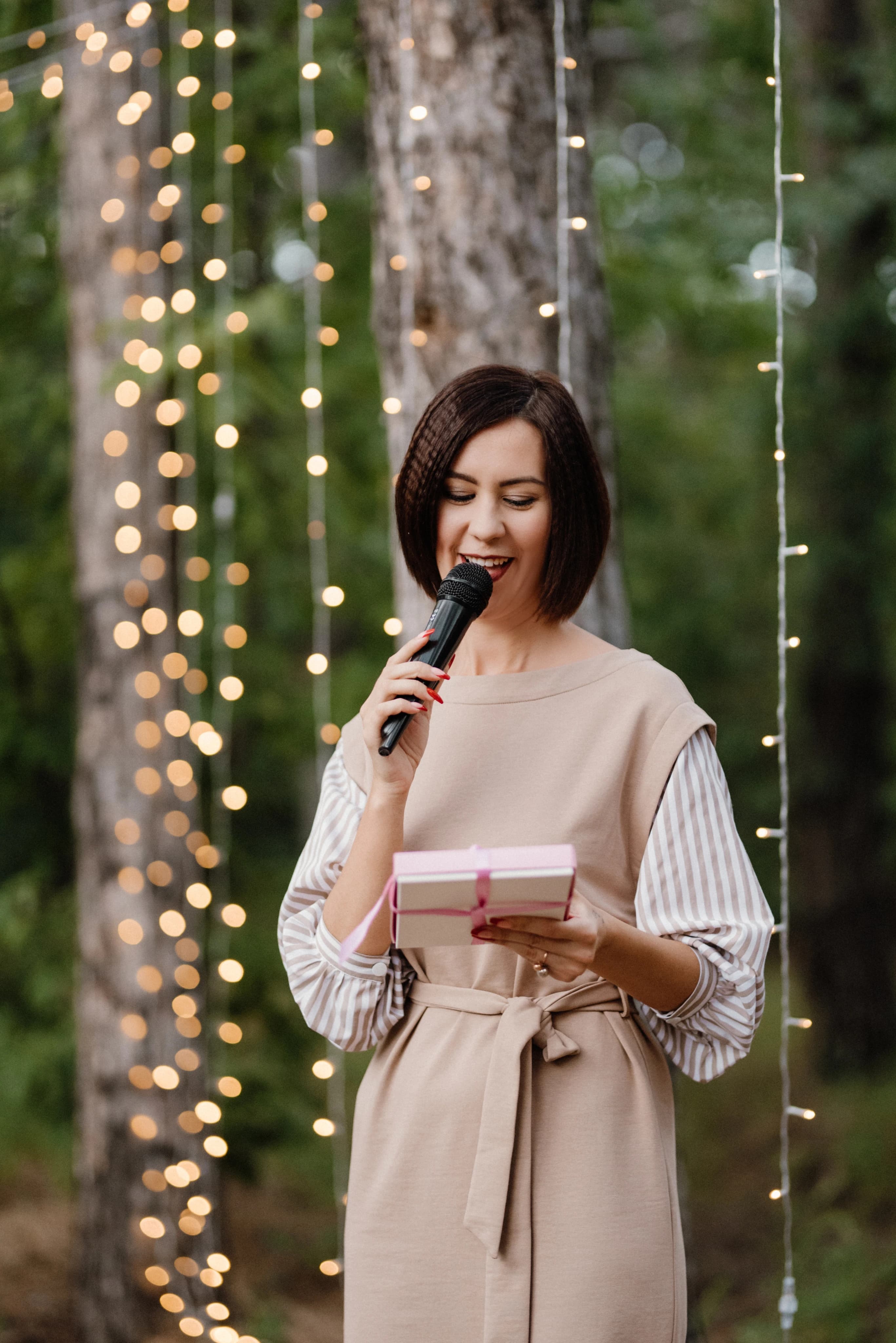 Master of Ceremonies speaking into microphone at an event